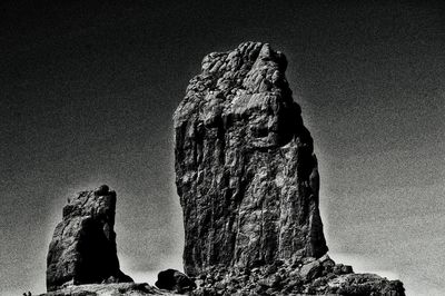 Low angle view of rock formation against sky