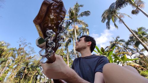 Low angle view of man holding hands