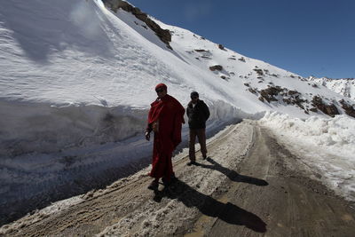 Woman skiing on snow covered mountain