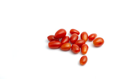 Close-up of tomatoes over white background