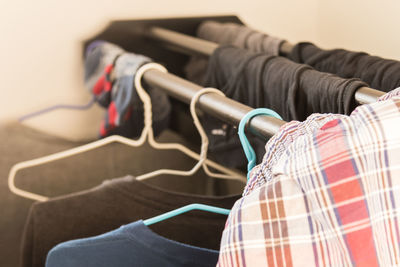 Close-up of clothes hanging on rack at home