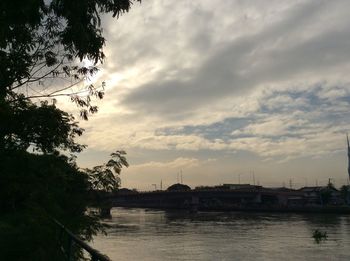 Scenic view of river against sky at sunset