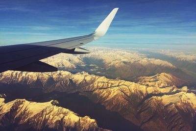 Cropped image of airplane flying over landscape