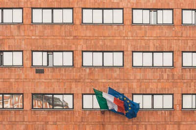 Low angle view of flag against building