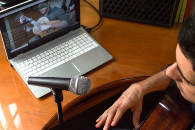 High angle view of man using laptop on table