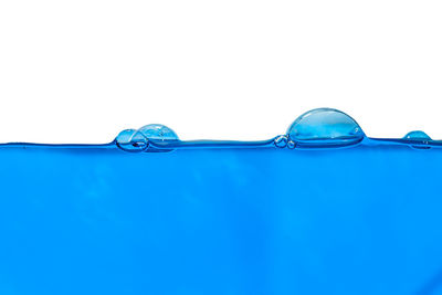 Close-up of blue water against white background