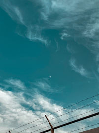Low angle view of cables against blue sky