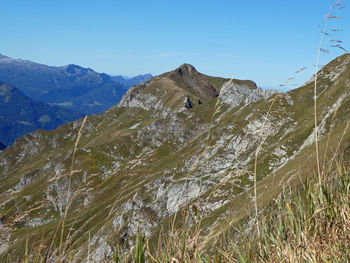 Scenic view of mountains against clear blue sky