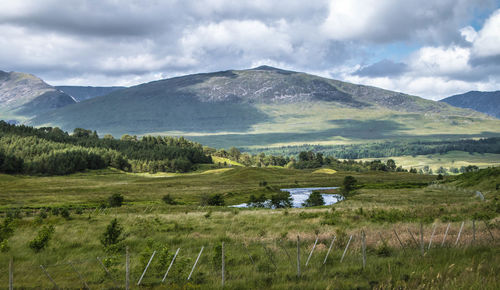 Scenic view of landscape and mountains against sky