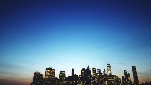 Low angle view of cityscape against clear sky