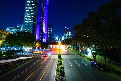 Illuminated city street at night