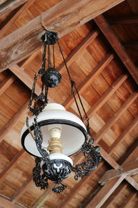 Low angle view of chandelier hanging on ceiling of building