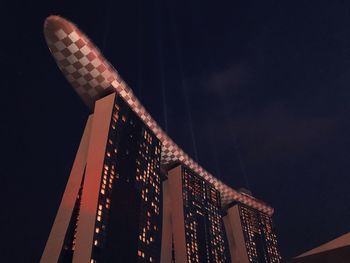 Low angle view of illuminated building against sky at night