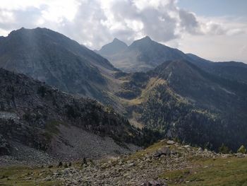 Scenic view of mountains against cloudy sky