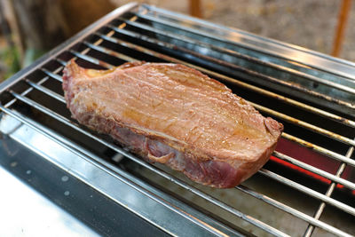 High angle view of meat on barbecue grill