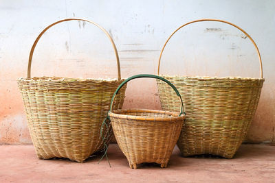 Close-up of wicker basket on table against wall