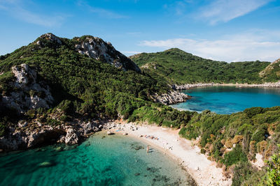 Scenic view of sea and mountains against sky