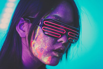 Beautiful young woman with face paint wearing eyewear