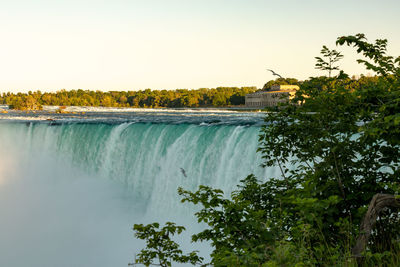 Scenic view of waterfall against clear sky