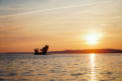 Scenic view of sea against romantic sky at sunset