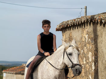 Portrait of man riding horse