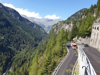 Panoramic view of road amidst trees against sky