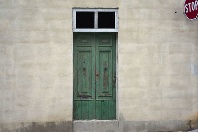 Closed green wooden door of house