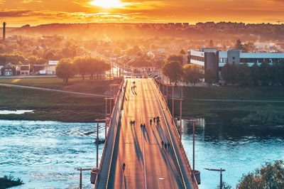 High angle view of bridge over river against sky at sunset