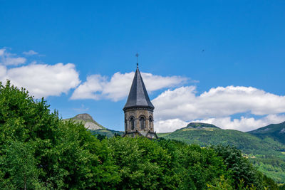 Temple by building against sky