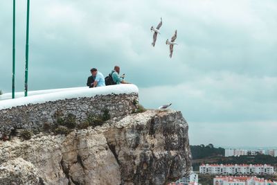 People in front of cityscape against sky