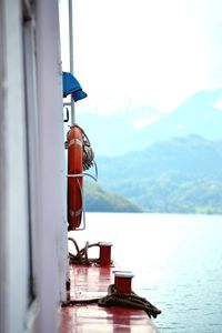 Life belt on boat in sea by mountains