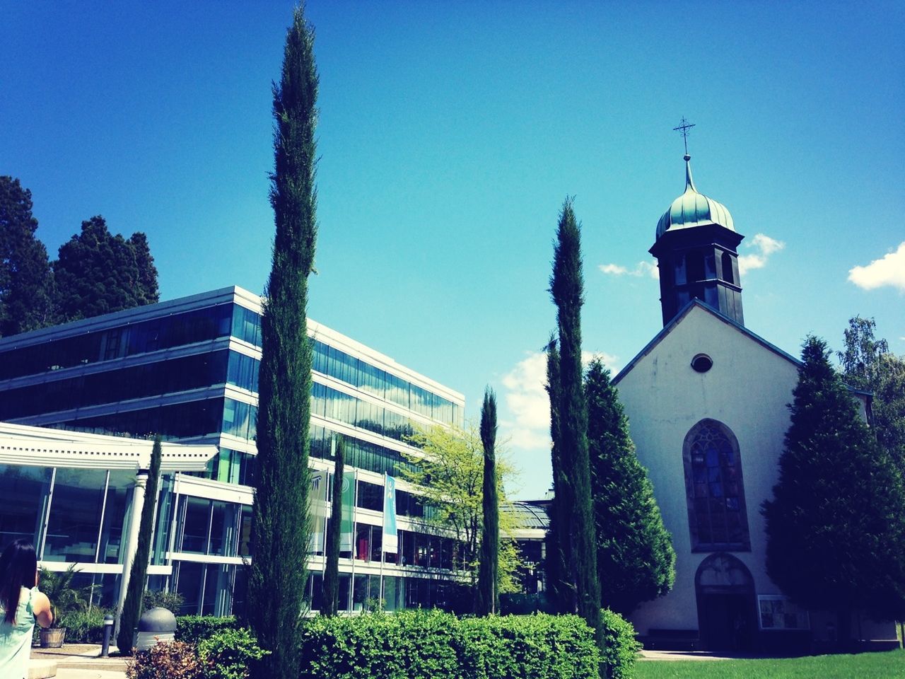 building exterior, architecture, built structure, place of worship, religion, church, spirituality, blue, tree, low angle view, clear sky, house, sky, cross, day, sunlight, steeple, cathedral