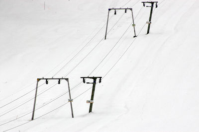 A ski lift, t-bar lift on a snowy mountain in winter