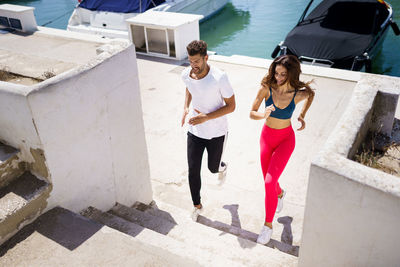 High angle view of couple exercising on steps