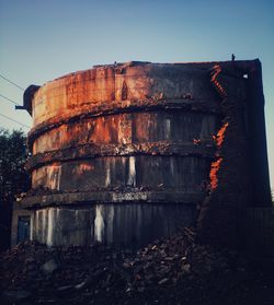 Low angle view of old abandoned building against clear sky