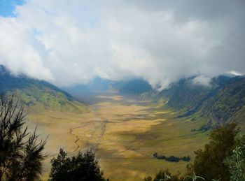 Scenic view of mountains against cloudy sky