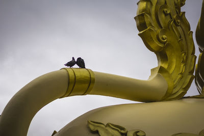 Low angle view of statue against sky