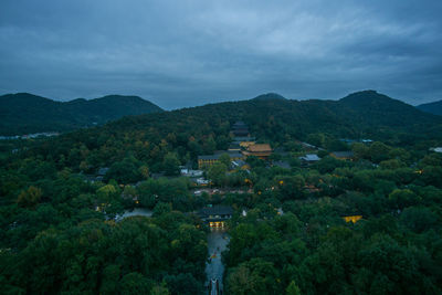 Scenic view of mountains and buildings against sky