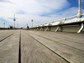 Pier on sea against cloudy sky