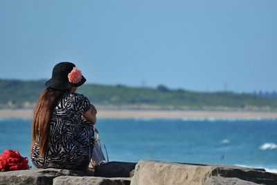 Woman sitting on rock