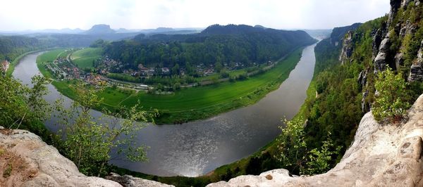 Panoramic view of river amidst mountains against sky