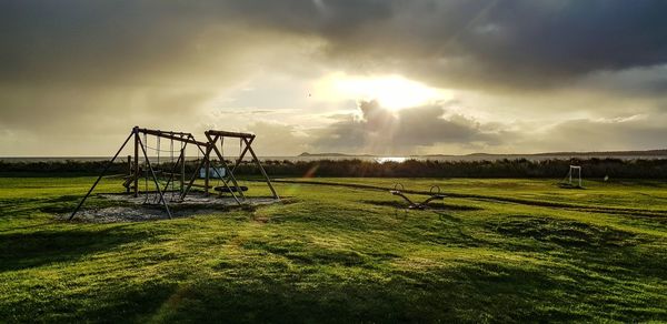 Scenic view of field against sky during sunset