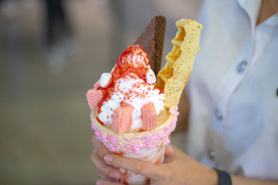 Close-up of hand holding ice cream cone