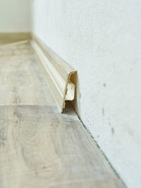 Close-up of wedding rings on floor against wall in building