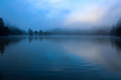 Scenic view of lake against sky during winter