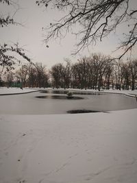 Scenic view of frozen lake against sky during winter