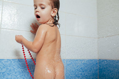 Naked girl taking shower in bathroom
