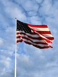 Low angle view of flag flags against sky