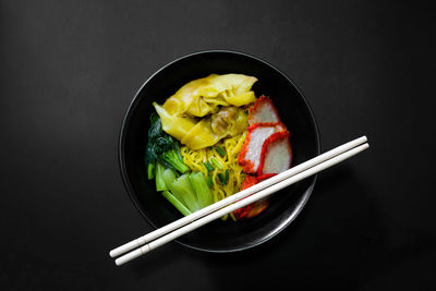 High angle view of food in bowl against black background