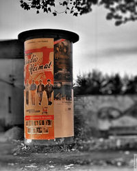 Close-up of information sign against sky